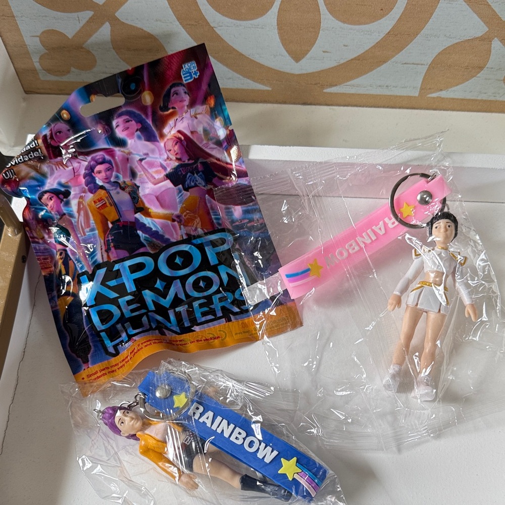 K-Pop Demon Hunters blind bag and 2 keychains with silicone wristlets.